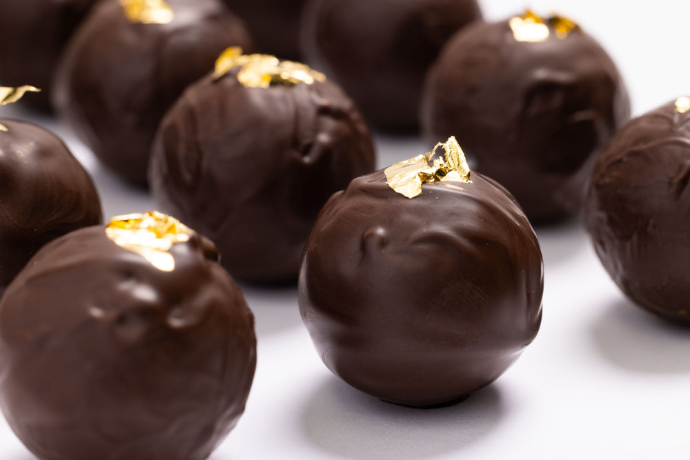 Premium New Year's Champagne Truffles 12-piece luxury gift box packaging by Cacao & Cardamom.