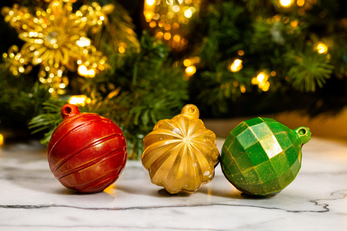 Ornament Hot Chocolate Bomb handcrafted with premium chocolate in a festive ornament design by Cacao & Cardamom.