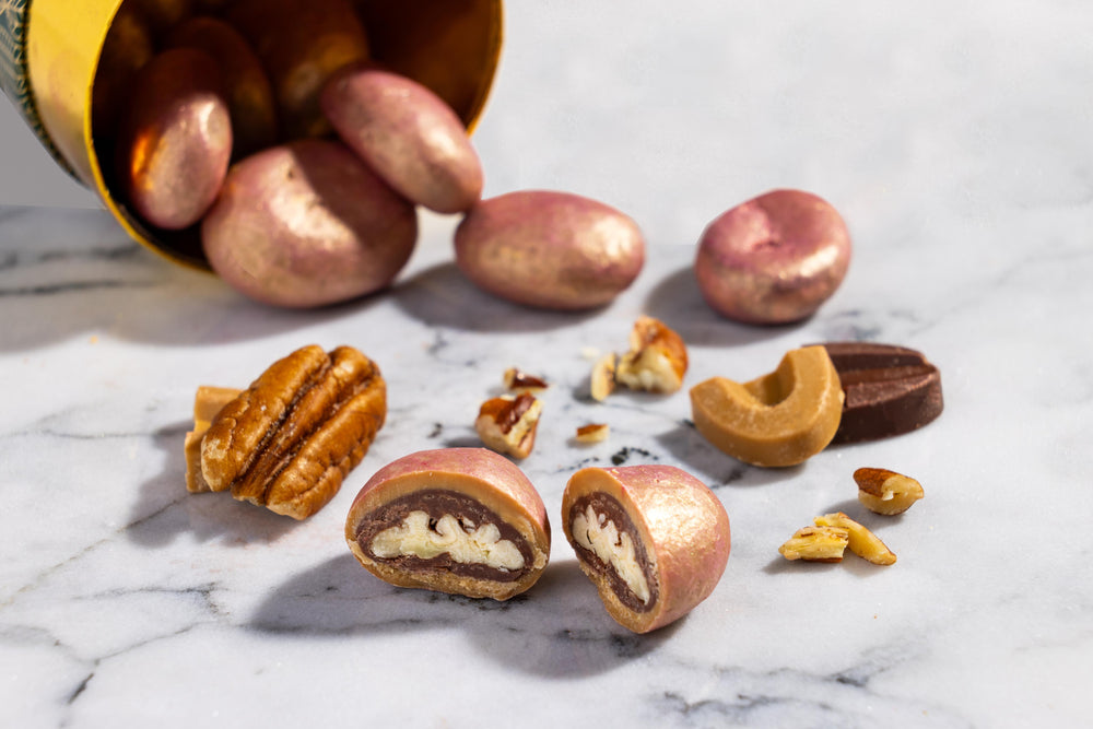 Close-up of Pecan Dulcey Dragees coated in handcrafted dulcey chocolate.