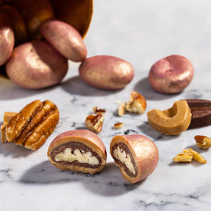 Close-up of Pecan Dulcey Dragees coated in handcrafted dulcey chocolate.