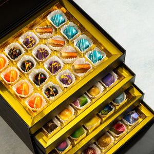 Close-up of handcrafted artisan bonbons from the Ultimate Bon-Bon Collection 80-piece gift box.