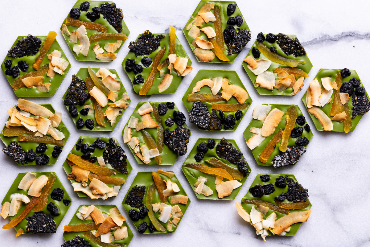 Open Matcha Mendiants displaying handcrafted gourmet chocolate discs.